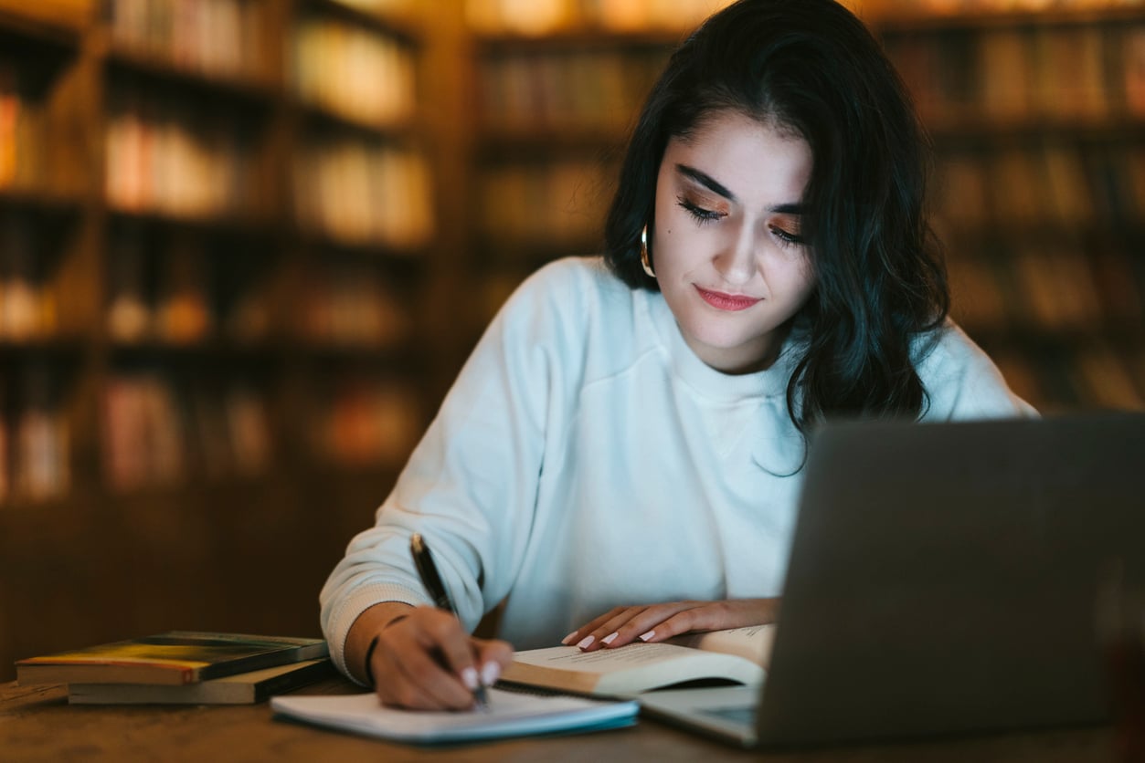 College student studying online at library