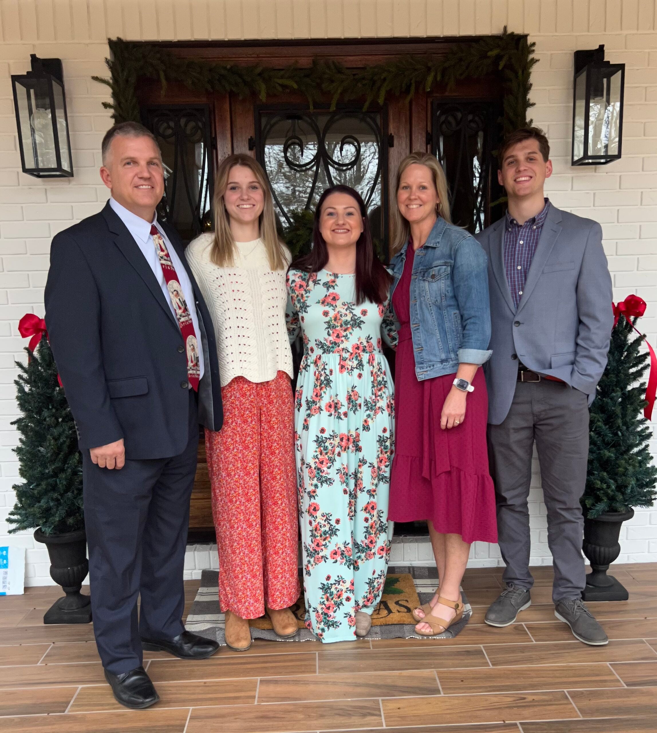 The Harris family poses in front of their front door.