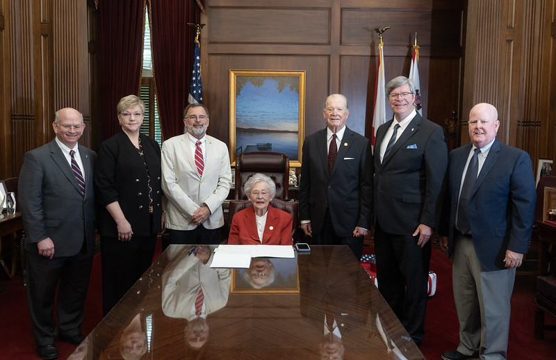 Alabama Governor's Office/Hal Yeager)
Cutline: l-r Faulkner Law Dean Charles Campbell, Vallee Connor, Speaker Pro Tem Chris Pringle, Governor Kay Ivey, Senator Jabo Waggoner, Faulkner President Mitch Henry, and John Craft. Governor Kay Ivey signs legislation, HB 96 on May 6, 2026.
